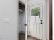 Bright entry features a white door with glass window and small closet with shelving on hardwood floors at 734 S State St, Raleigh, NC 27601