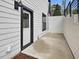 Exterior shot of a home with white siding, dark trim, and a private entry at 734 S State St, Raleigh, NC 27601