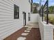 Exterior view of a home showcasing a white siding, dark trim, and private entry at 734 S State St, Raleigh, NC 27601