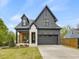 Beautiful two-story home with a gray brick exterior, a two-car garage, and a cozy front porch at 734 S State St, Raleigh, NC 27601