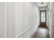 Well-lit hallway with light walls and wood flooring, featuring elegant trim details at 734 S State St, Raleigh, NC 27601