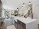 A modern kitchen and dining area with white countertops, stainless appliances, and an open floor plan at 734 S State St, Raleigh, NC 27601