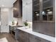 A modern kitchen featuring stainless steel appliances, white countertops, and dark brown cabinets at 734 S State St, Raleigh, NC 27601