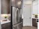 A kitchen featuring stainless steel refrigerator, and white countertops with dark brown cabinets at 734 S State St, Raleigh, NC 27601