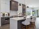 A modern kitchen with stainless steel appliances, white countertops, and a large island with seating at 734 S State St, Raleigh, NC 27601