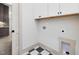 This laundry room features black and white tile floors, white cabinets, and utility connections at 734 S State St, Raleigh, NC 27601