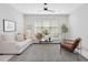Bright living room with white sofas, neutral decor, and a window for ample natural light at 734 S State St, Raleigh, NC 27601