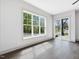 Bright living room with hardwood floors and plenty of natural light from large windows and sliding glass doors at 734 S State St, Raleigh, NC 27601
