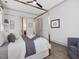 This main bedroom features a four-poster bed, hardwood floors, neutral walls, and a ceiling fan at 734 S State St, Raleigh, NC 27601