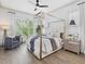 Bright main bedroom suite with a four-poster bed, hardwood floors, and ample natural light at 734 S State St, Raleigh, NC 27601