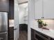 A butler's pantry with white shelves and dark brown cabinets, countertops, and drawers at 734 S State St, Raleigh, NC 27601