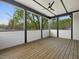Spacious screened-in porch with wooden floors and a view of the lush backyard at 734 S State St, Raleigh, NC 27601