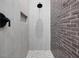 Contemporary shower with gray brick-like tiles, light-colored tiles, and a black shower head at 734 S State St, Raleigh, NC 27601