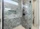 This shower features herringbone tile, a shower niche, a glass enclosure, and a black shower head at 734 S State St, Raleigh, NC 27601