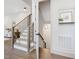 Staircase featuring modern railings, wooden steps, and neutral decor at 734 S State St, Raleigh, NC 27601