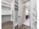 This walk-in closet features wood floors, built-in shelving and rods, and a mirror at 734 S State St, Raleigh, NC 27601