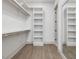 This walk-in closet features wood floors, built-in shelving and rods, and a mirror at 734 S State St, Raleigh, NC 27601