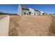 View of the backyard showing lawn and siding of home at 8 Steppe Way, Garner, NC 27529