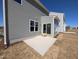 Back of home with patio and sliding glass door, view of lawn at 8 Steppe Way, Garner, NC 27529