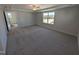 Spacious primary bedroom featuring a ceiling fan, neutral carpet, and a window for natural light at 8 Steppe Way, Garner, NC 27529