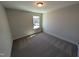 Neutral bedroom featuring carpeted floors, a window for natural light, and fresh paint at 8 Steppe Way, Garner, NC 27529