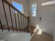 Bright foyer featuring hardwood floors, staircase, and natural light at 8 Steppe Way, Garner, NC 27529