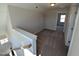 Upstairs hallway with carpet, white trim, storage nook, and view to bedroom at 8 Steppe Way, Garner, NC 27529