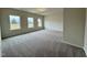 Large bedroom with neutral carpet, three windows, and plenty of space at 108 Commons Circle # 228, Clayton, NC 27520