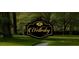 Elegant community sign reading 'Wellesley', surrounded by mature trees and a manicured lawn at 108 Commons Circle # 228, Clayton, NC 27520