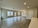 Spacious, open-concept living room and dining area with hardwood flooring and ample natural light at 108 Commons Circle # 228, Clayton, NC 27520