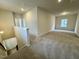Upstairs loft space with carpet, natural light, and an open railing at 108 Commons Circle # 228, Clayton, NC 27520