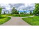 Scenic park view with lush green grass, mature trees, and walking paths under a cloudy sky at 108 Commons Circle # 228, Clayton, NC 27520