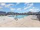 Community swimming pool with lounge chairs and a cabana area for residents to enjoy at 108 Commons Circle # 228, Clayton, NC 27520