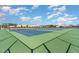 Well-maintained tennis courts with blue playing surfaces and green borders, under a bright blue sky at 108 Commons Circle # 228, Clayton, NC 27520