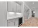 Elegant bar area with custom cabinetry, a wine cooler, and a stylish backsplash at 1721 Burnette Garden Path, Raleigh, NC 27612
