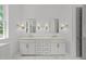 Bright bathroom with dual vanities, sconce lighting, and tiled floors at 1721 Burnette Garden Path, Raleigh, NC 27612