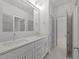 Bathroom with double vanity, quartz counters, tile floors and modern lighting at 1721 Burnette Garden Path, Raleigh, NC 27612