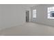 A spacious bedroom with two windows and a walk-in closet entrance provides ample natural light and storage at 1721 Burnette Garden Path, Raleigh, NC 27612