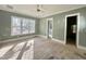 A serene bedroom with large windows, and a view into the primary bath providing a peaceful retreat at 1721 Burnette Garden Path, Raleigh, NC 27612