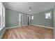 Bedroom features hardwood floors, a ceiling fan, and a view of the bathroom at 1721 Burnette Garden Path, Raleigh, NC 27612