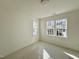 This room has two windows that let in plenty of natural light, creating a bright and airy atmosphere at 1721 Burnette Garden Path, Raleigh, NC 27612