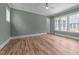 Bright bedroom with hardwood floors and large windows providing ample natural light at 1721 Burnette Garden Path, Raleigh, NC 27612