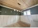 An elegant dining room showcases wood floors, ceiling, wainscoting, complemented by an ornate, linear chandelier at 1721 Burnette Garden Path, Raleigh, NC 27612