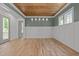 Elegant dining room featuring wood ceiling, wainscoting, and modern chandelier at 1721 Burnette Garden Path, Raleigh, NC 27612