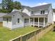 Exterior view of home with rear screened-in porch, lush lawn, and wooden fence at 1721 Burnette Garden Path, Raleigh, NC 27612