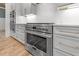 Gourmet kitchen with stainless steel appliances, white cabinetry, and a stylish backsplash at 1721 Burnette Garden Path, Raleigh, NC 27612