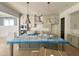 An expansive kitchen design with modern, gray cabinets, gold pendant lights, and a spacious island, perfect for cooking at 1721 Burnette Garden Path, Raleigh, NC 27612