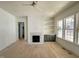 A bright living room with large windows, a stylish fireplace, custom built-ins, and inviting atmosphere at 1721 Burnette Garden Path, Raleigh, NC 27612