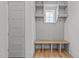 An organized mudroom with built-in shelves, hooks, and a bench creates a functional and stylish entry point at 1721 Burnette Garden Path, Raleigh, NC 27612