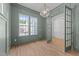 Bright office with hardwood floors, wainscoting, and modern lighting fixtures at 1721 Burnette Garden Path, Raleigh, NC 27612